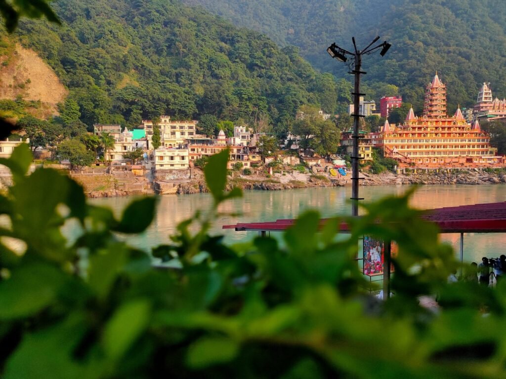 brown and white concrete buildings beside body of water